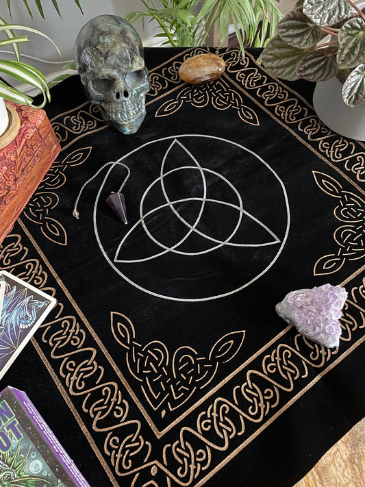 Pictured is a black velvet altar cloth with a silver triquetra in the middle.