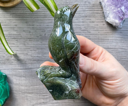 Pictured is a bird or raven carved out of moss agate.