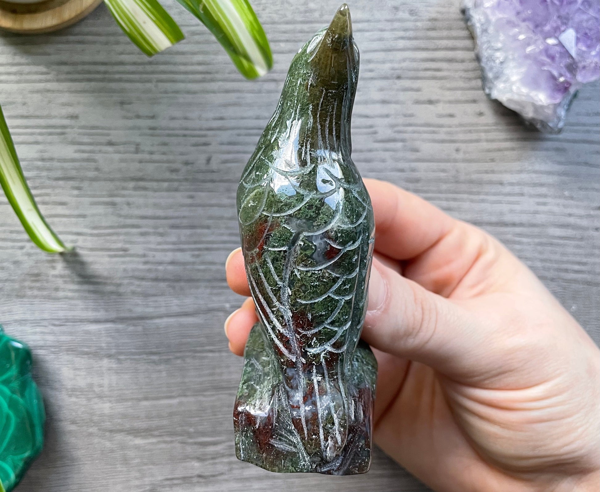 Pictured is a bird or raven carved out of moss agate.
