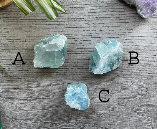 Pictured are various pieces of raw ice blue fluorite