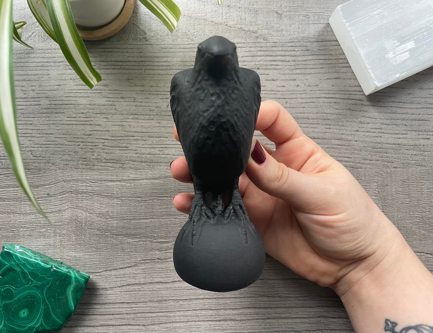 Pictured is a raven carved out of black obsidian.