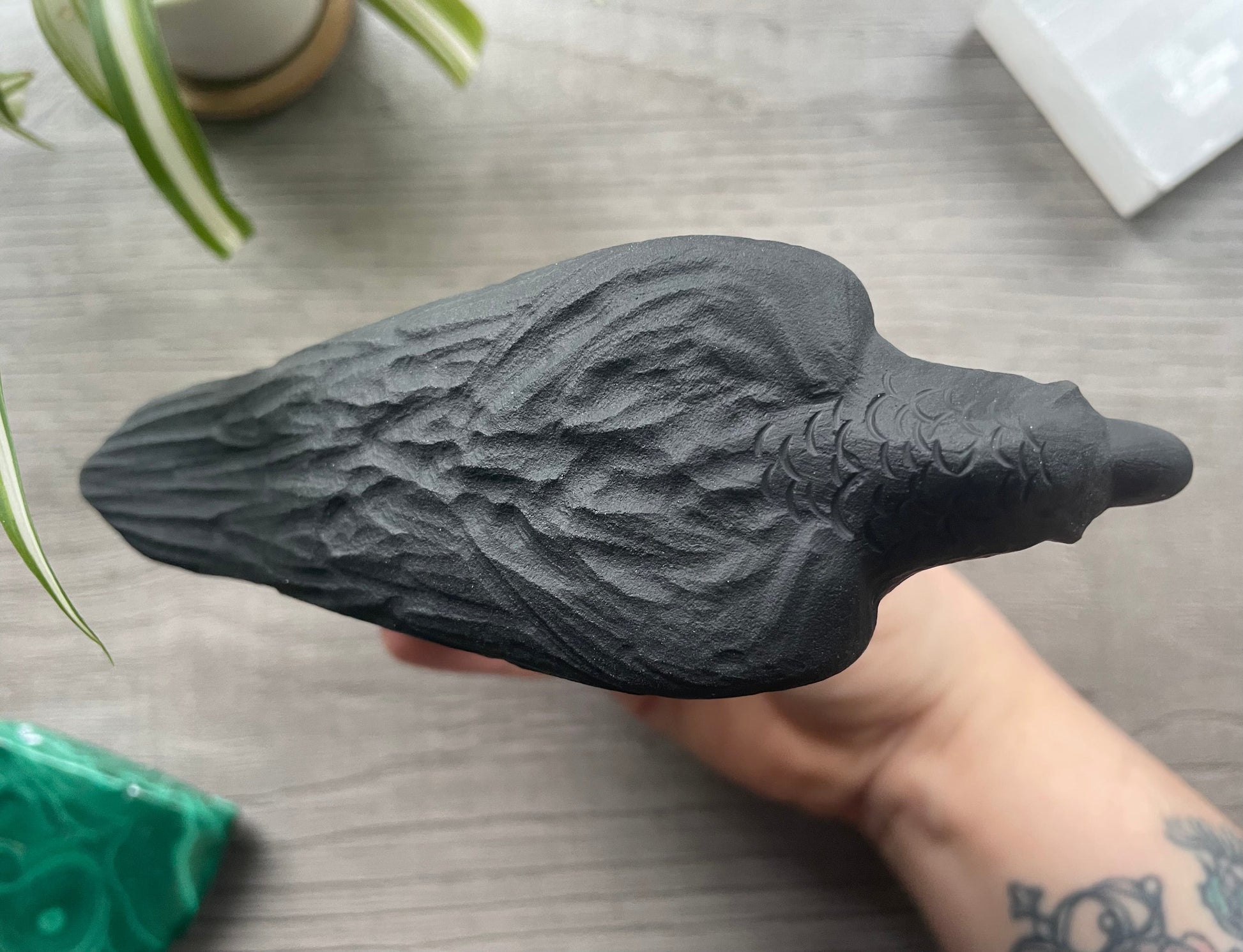 Pictured is a raven carved out of black obsidian.