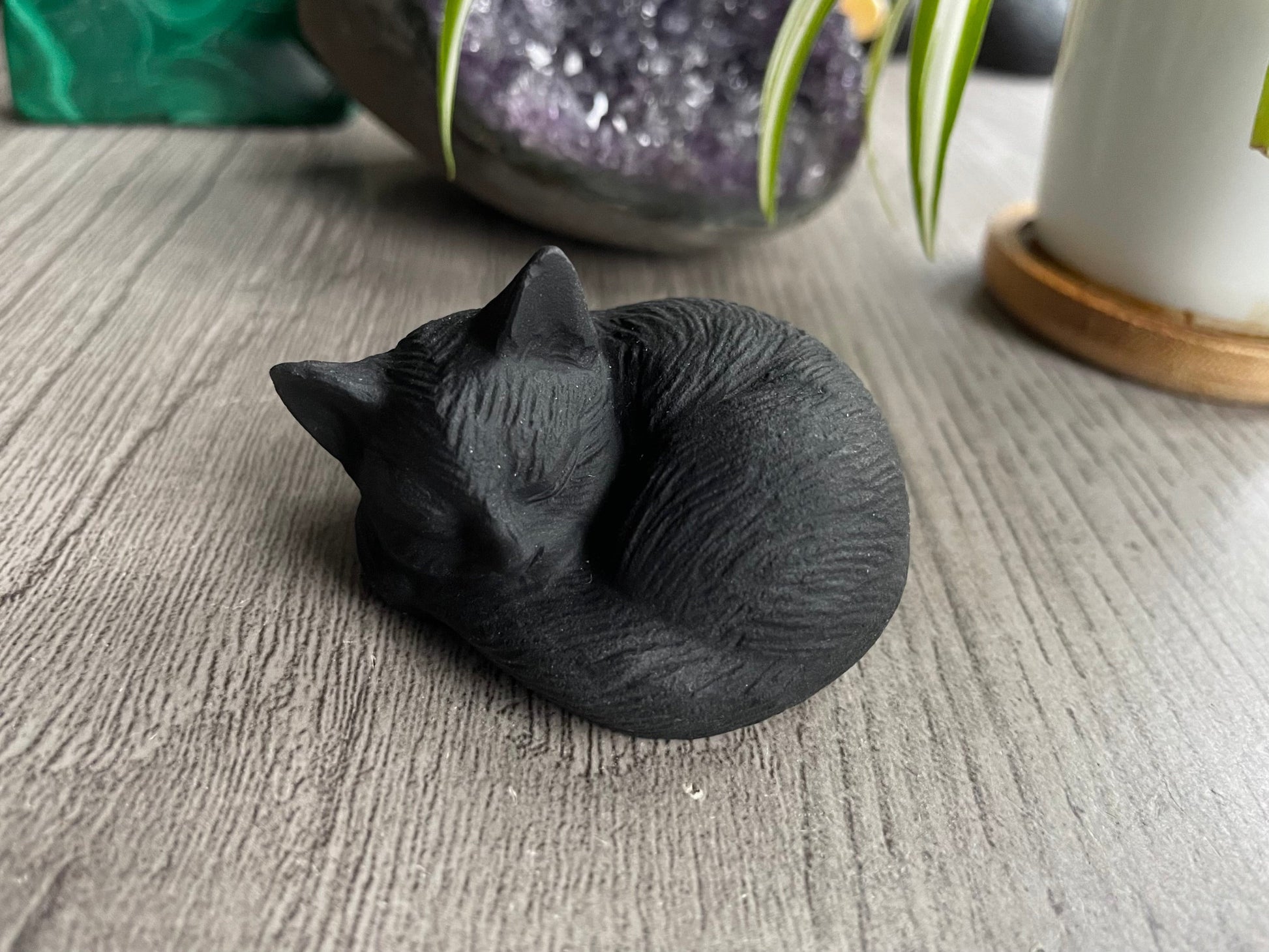 Pictured is a cat carved out of black obsidian.