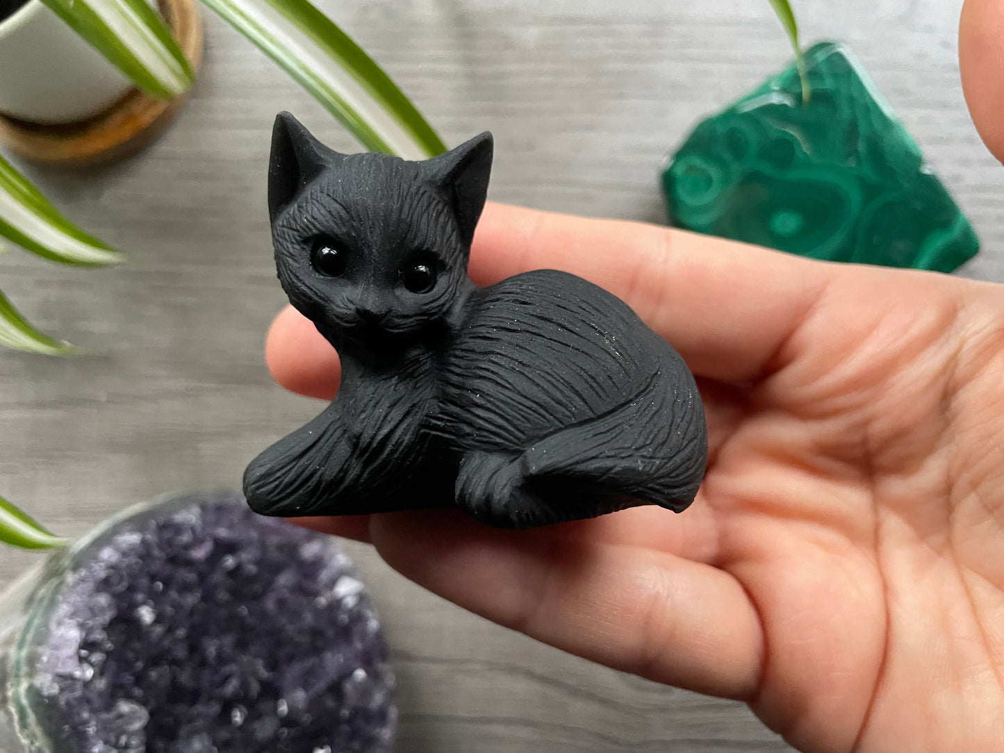 Pictured is a cat carved out of black obsidian.