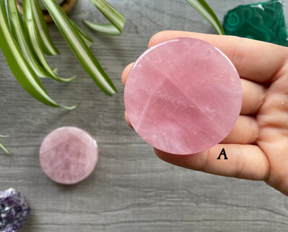 Pictured is a rose quartz crystal coin.