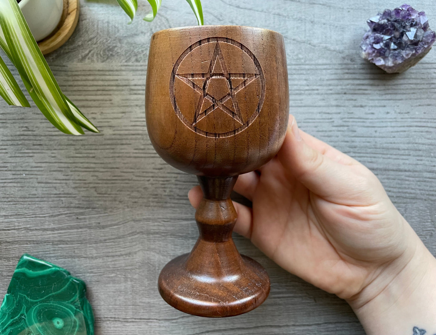 Pictured are various wood goblets with pentagrams on them.
