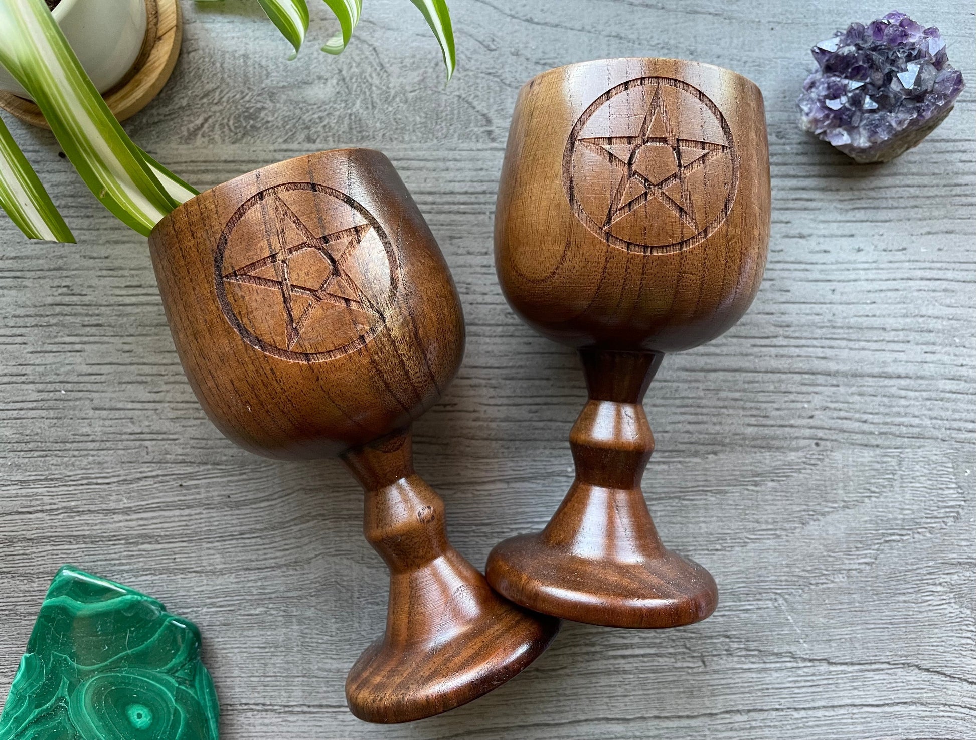 Pictured are various wood goblets with pentagrams on them.