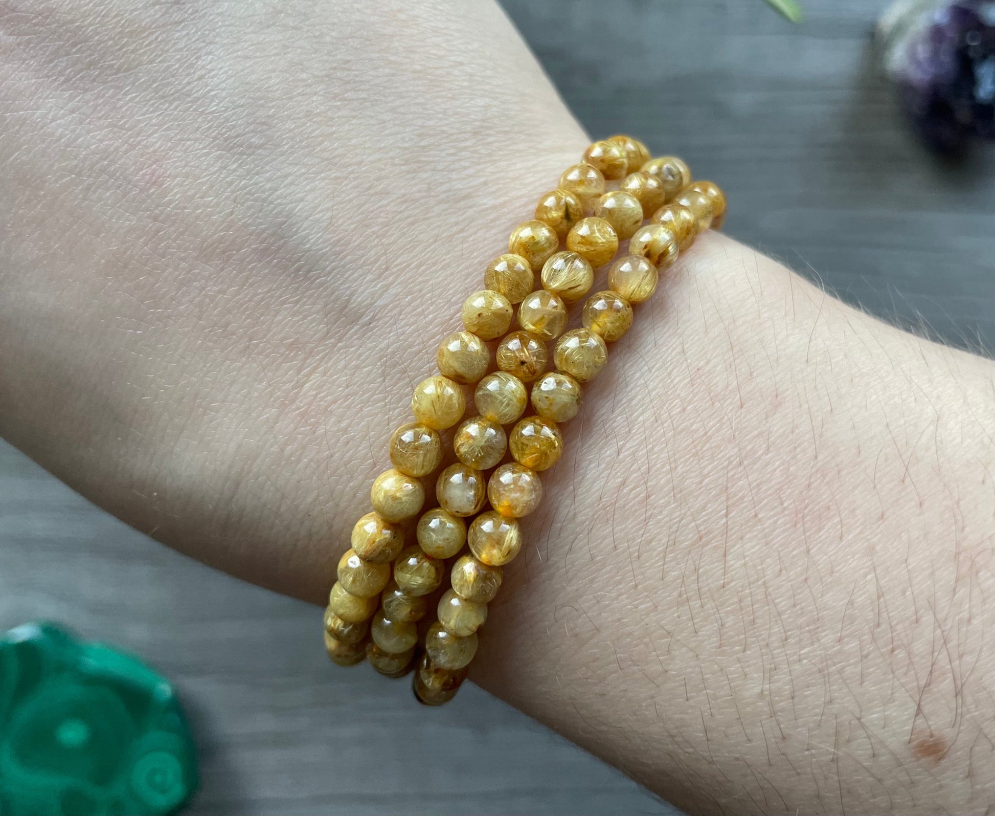 Pictured is a rutilated quartz bead bracelet.