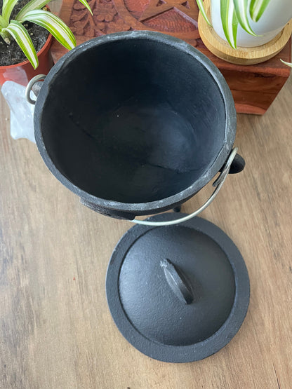 Pictured is a cast iron cauldron with lid.