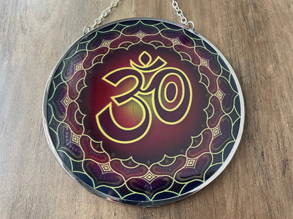 Pictured is a suncatcher with the "OM" symbol in the middle.
