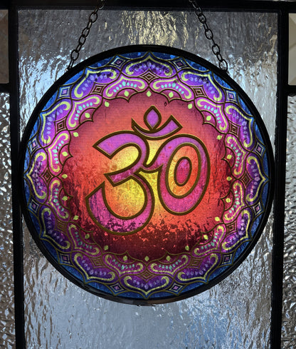 Pictured is a suncatcher with the "OM" symbol in the middle.