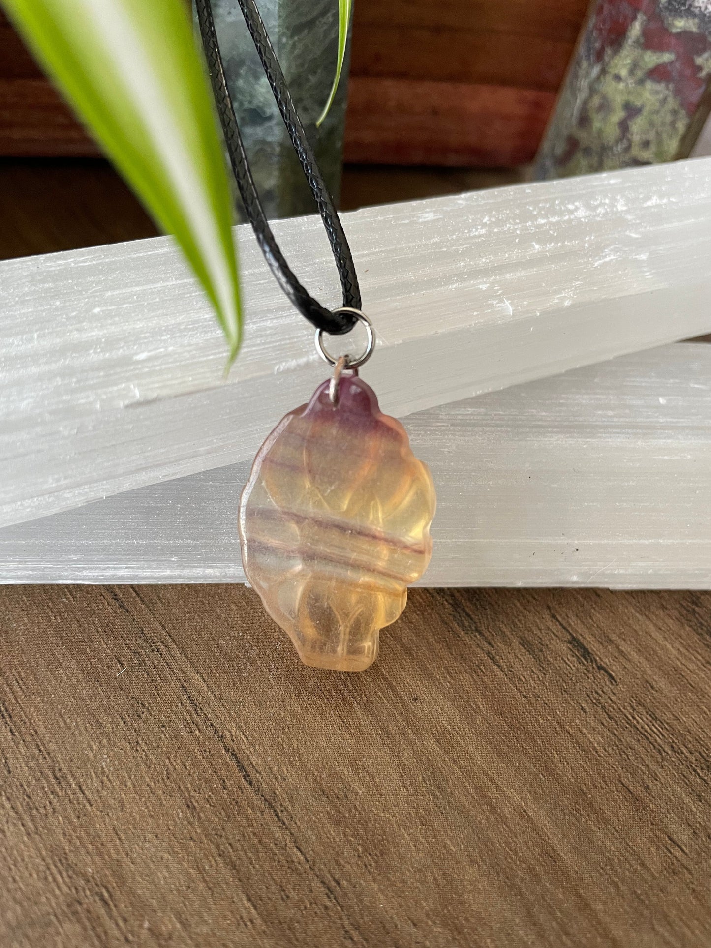 Pictured is a nine-tailed fox yellow fluorite necklace.