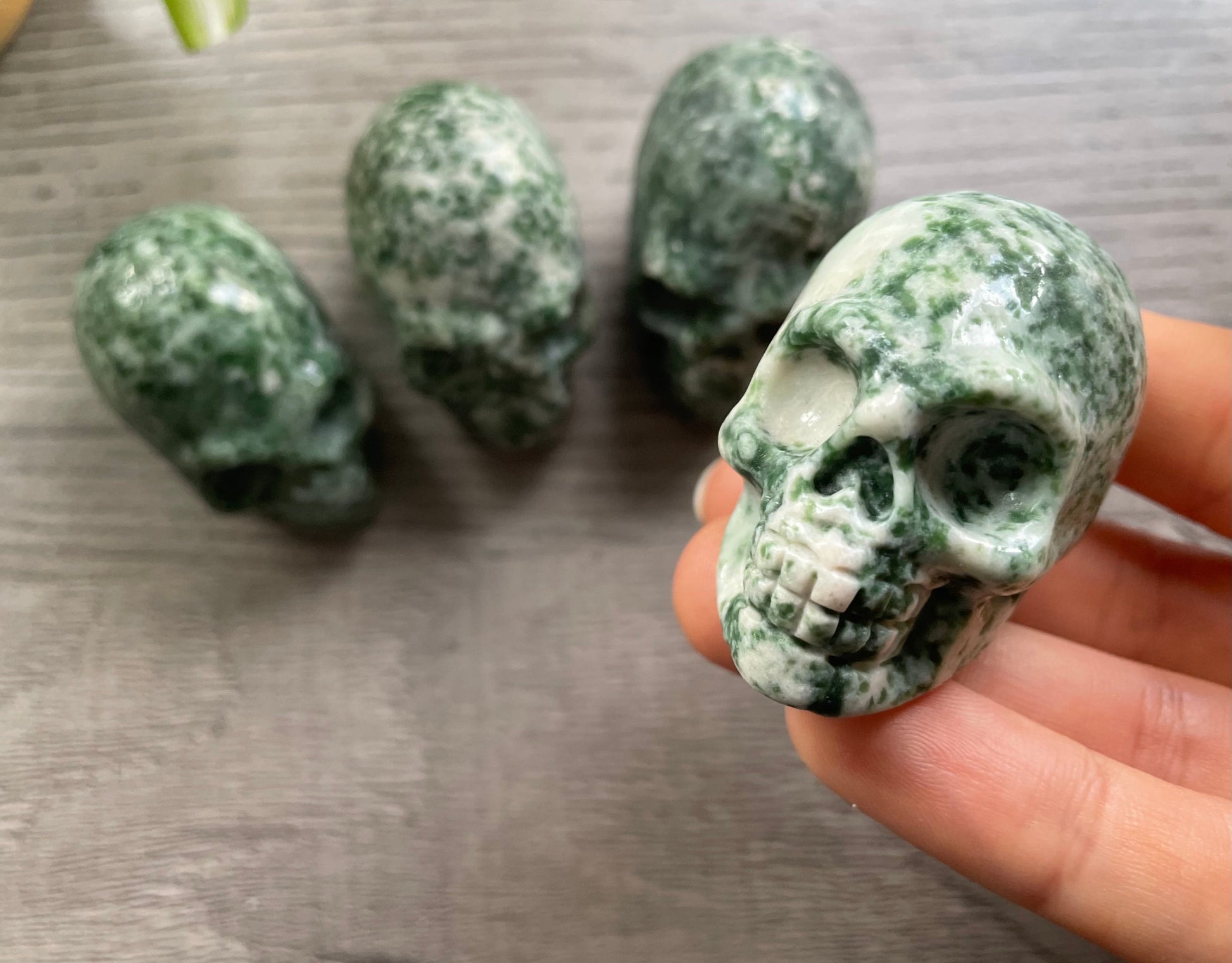 Pictured are various small skulls carved out of ching hai "jade"