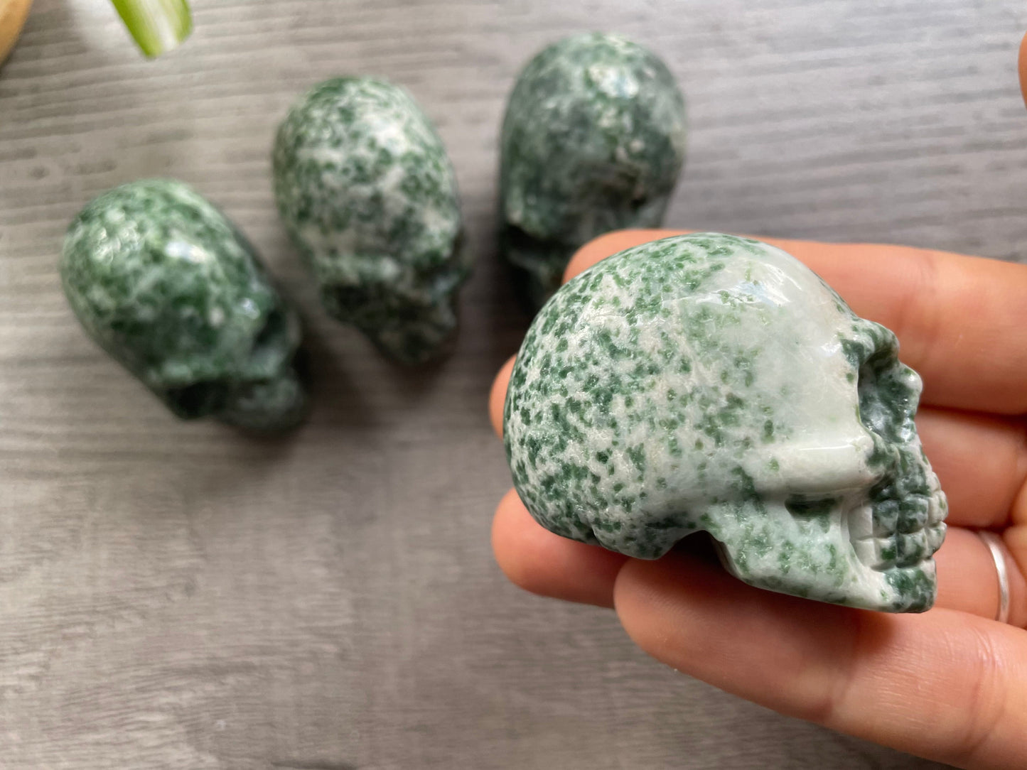 Pictured are various small skulls carved out of ching hai "jade"