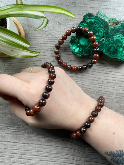 Pictured is a mahogany obsidian bead bracelet.
