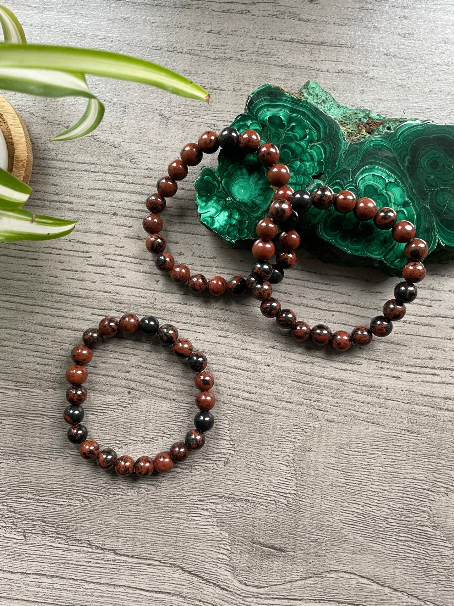 Pictured is a mahogany obsidian bead bracelet.