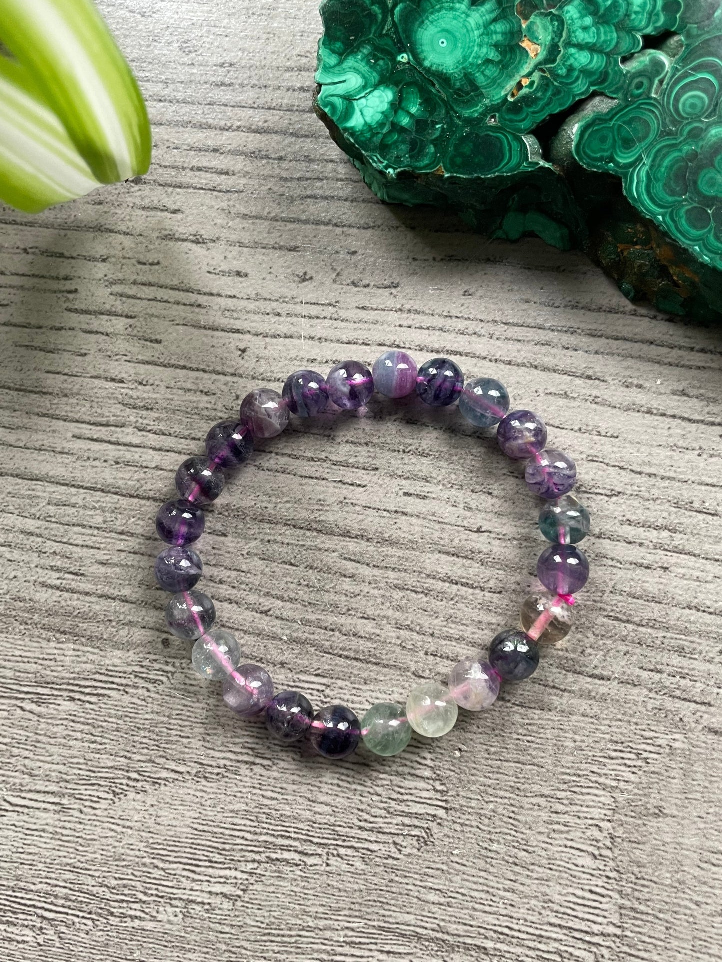 Pictured is a rainbow fluorite bead bracelet.