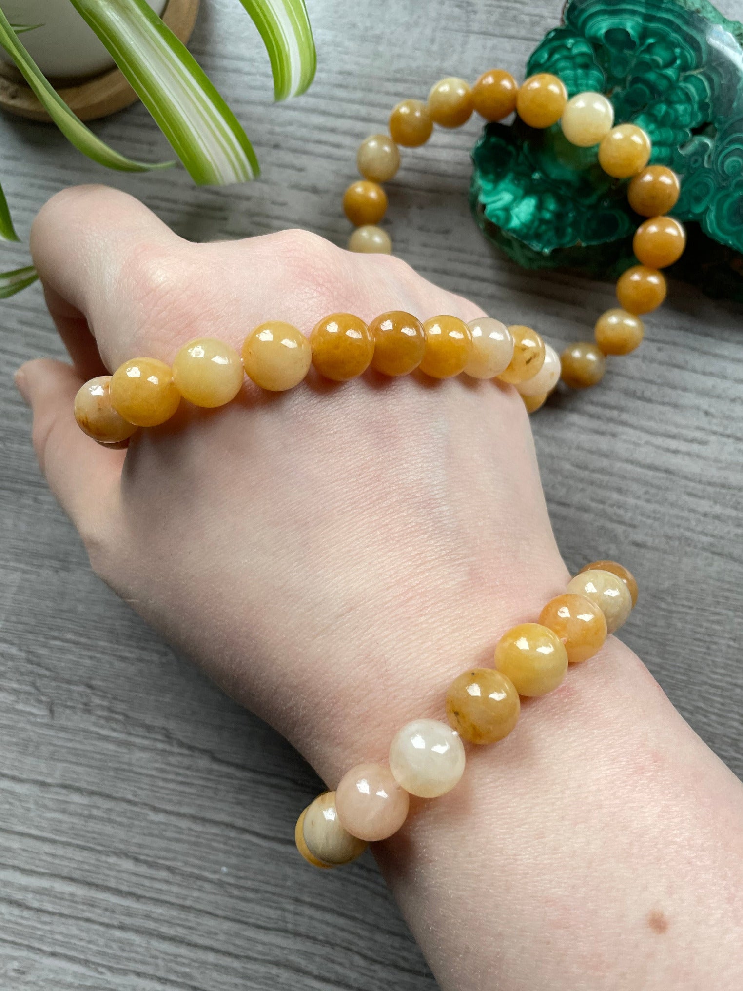 Pictured is a yellow jade bead bracelet.