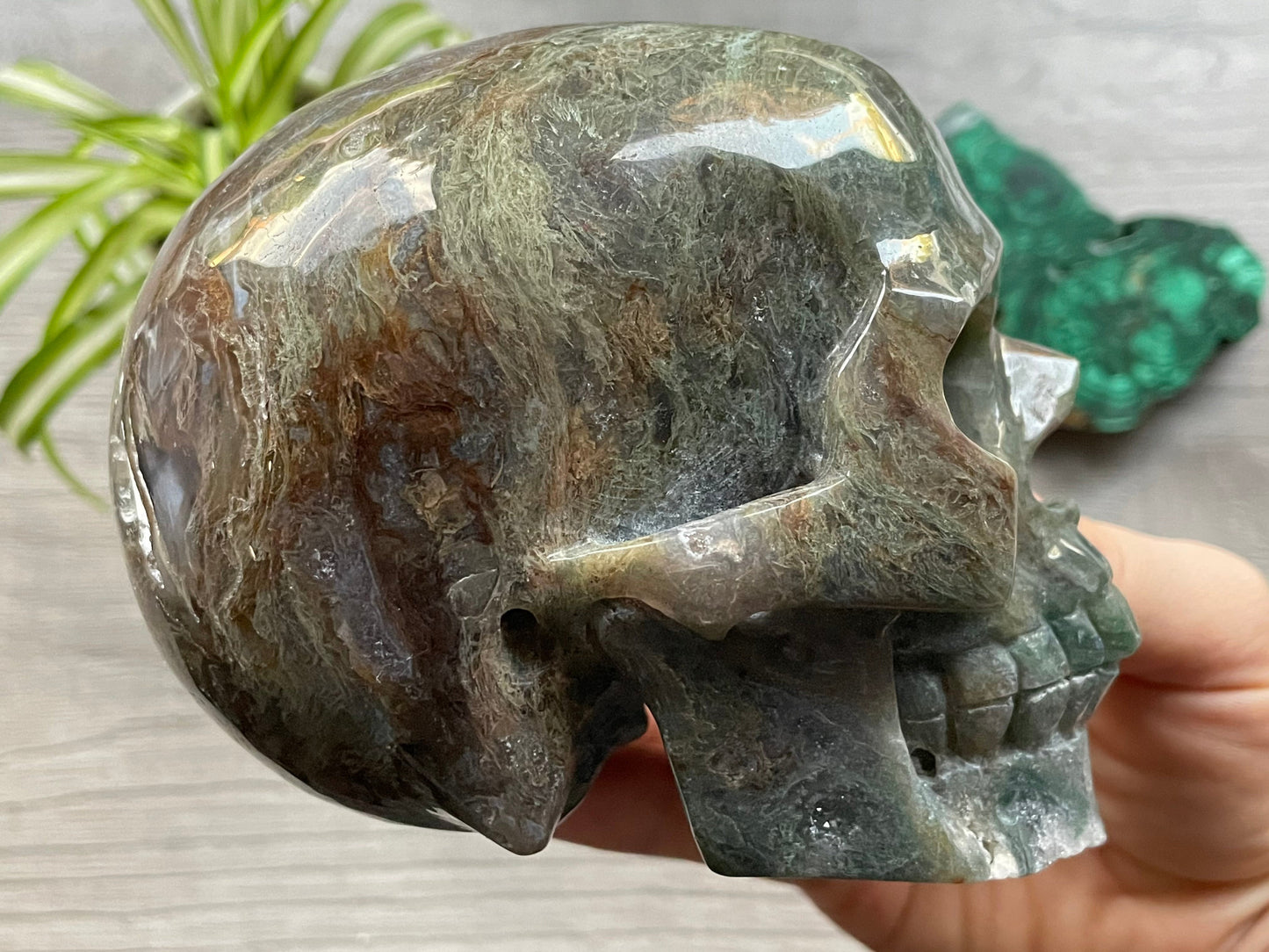 Pictured is a large skull carved out of moss agate.