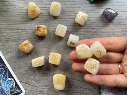 Pictured are reiki symbol stones carved out of golden healer tumbled crystals.