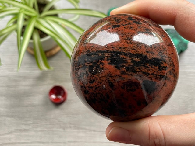 Pictured is a sphere carved out of mahogany obsidian.