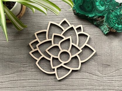 Pictured is a wood sphere stand in the shape of a lotus flower.