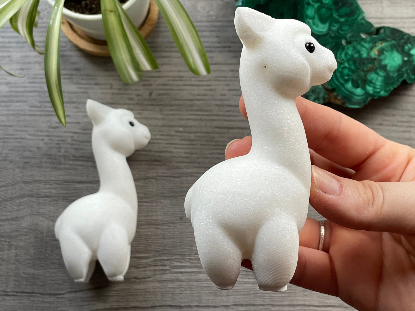 Pictured is an alpaca or llama carved out of white marble.