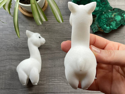 Pictured is an alpaca or llama carved out of white marble.