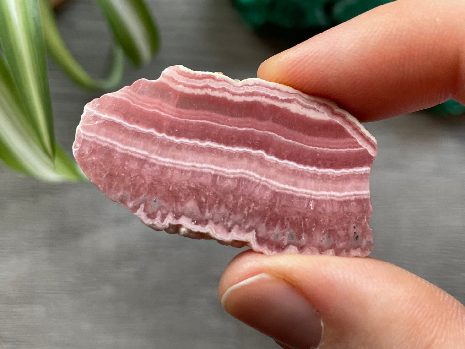 Pictured is a small slab of rhodochrosite.