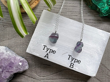 Pictured are various rainbow fluorite fox necklaces.