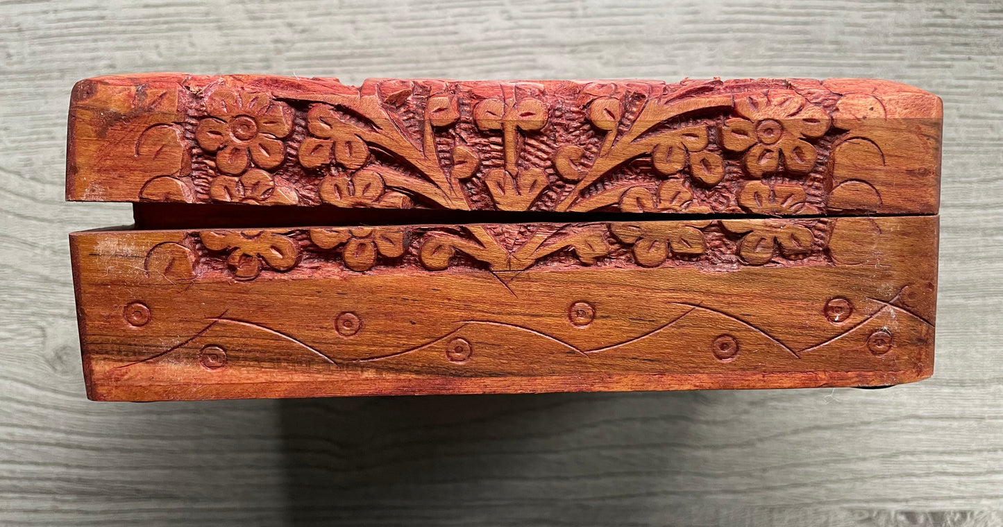 Pictured is hand-carved wood box with a tree of life in the middle.