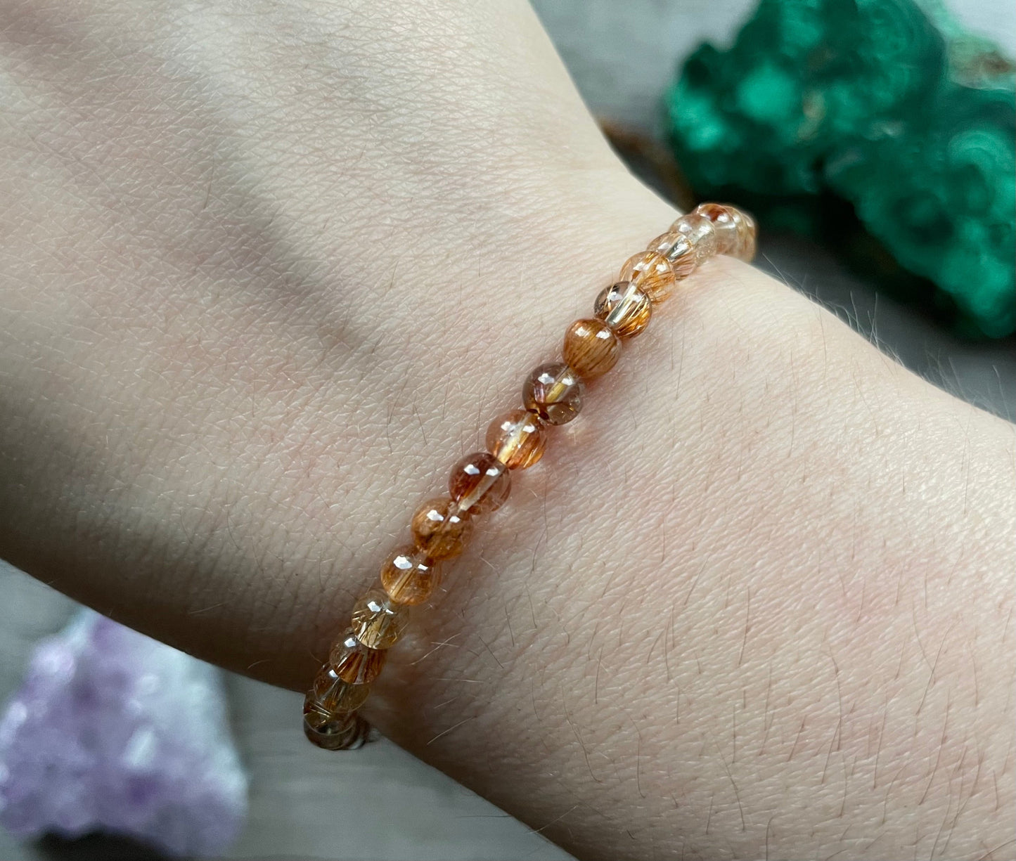 Pictured is a rutilated quartz bead bracelet.
