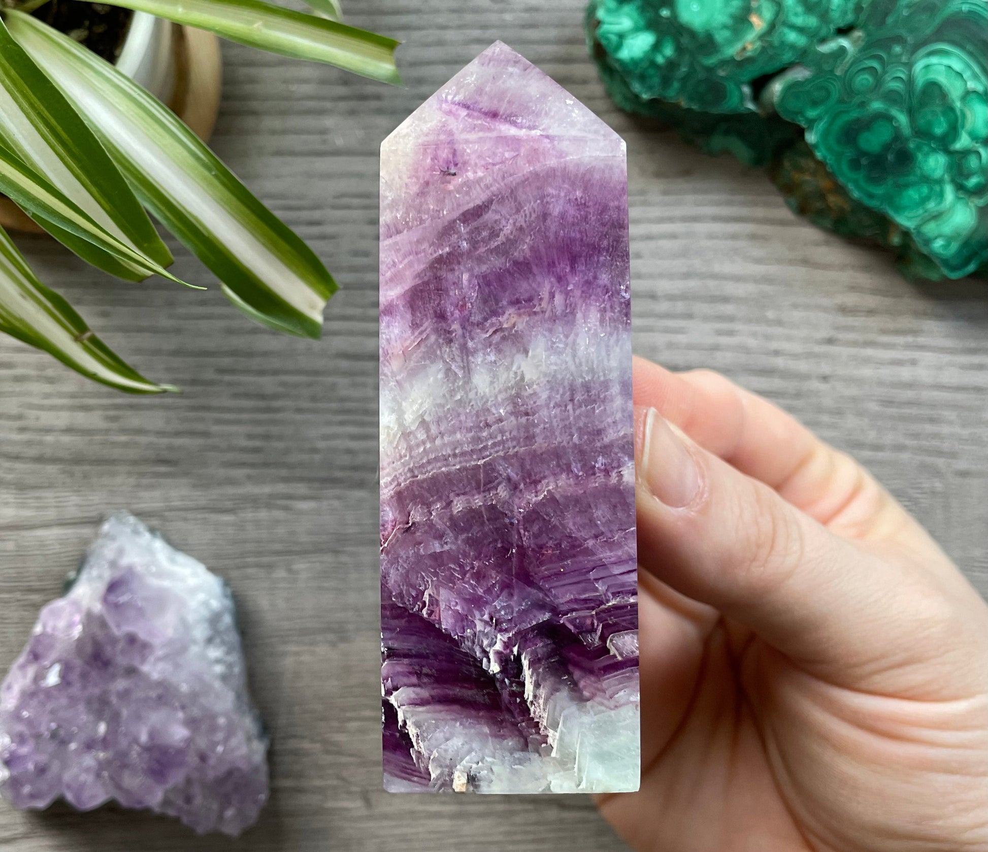 Pictured is a pink and purple fluorite obelisk. 