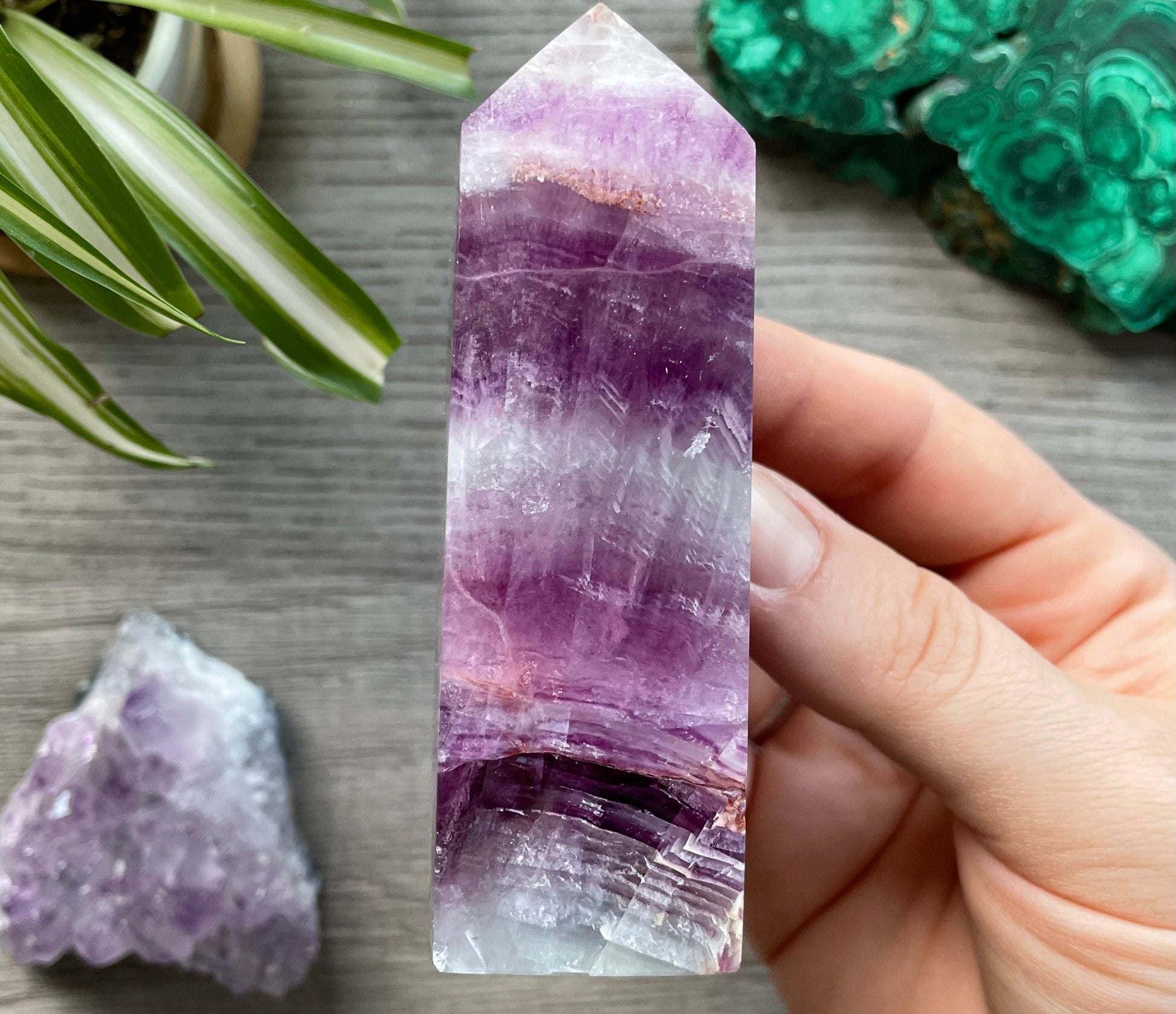 Pictured is a pink and purple fluorite obelisk. 