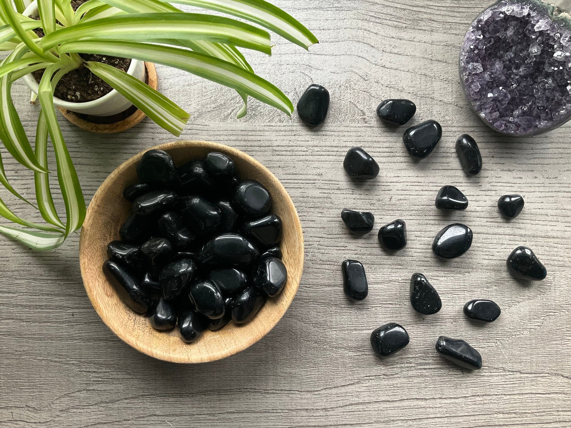 Pictured are various black obsidian tumbled stones.