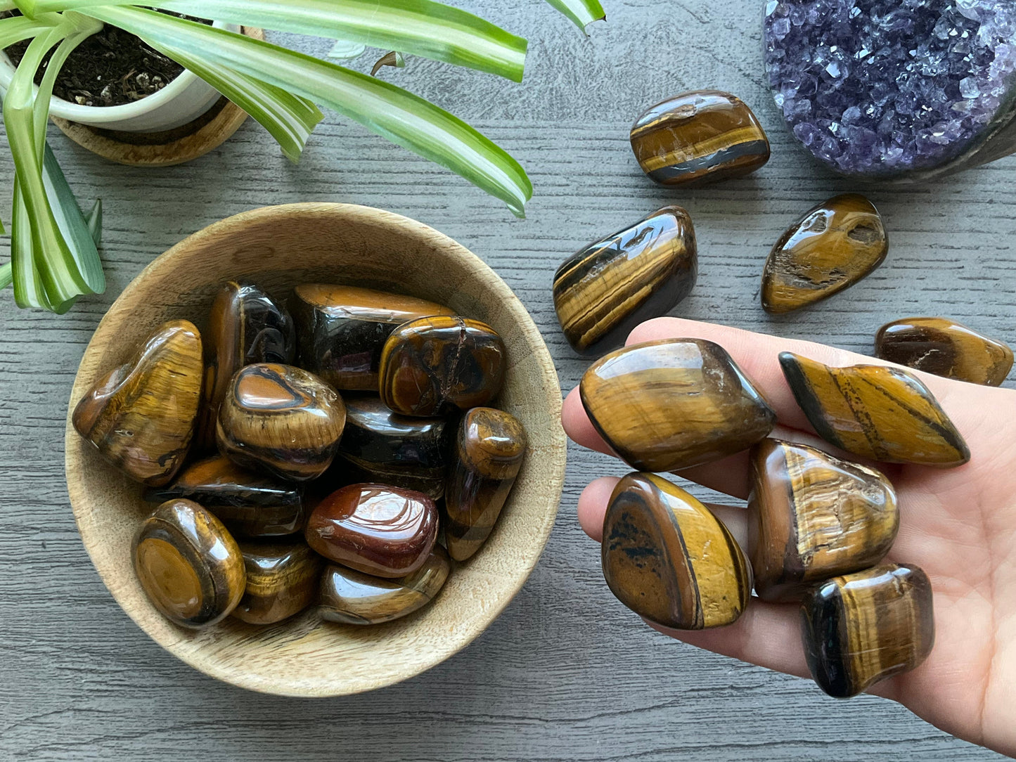Pictured are various tiger's eye tumbled stones.