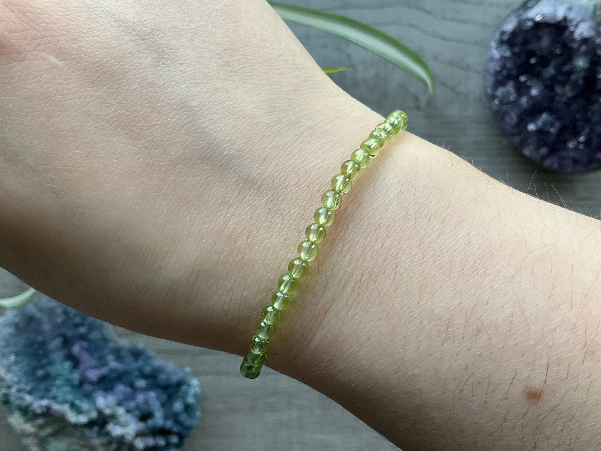 Pictured is a peridot bead bracelet.