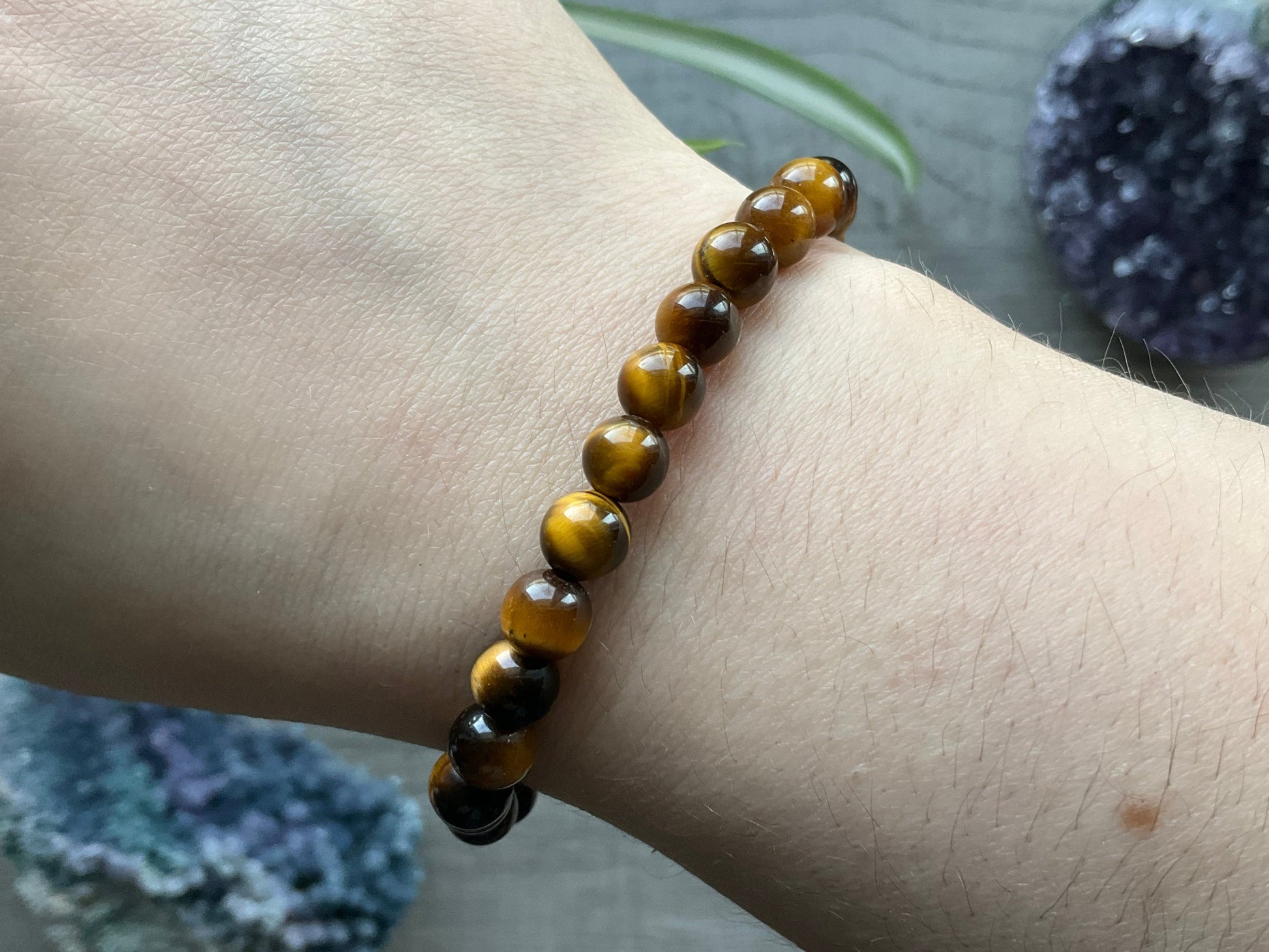 Pictured is a yellow tiger's eye bead bracelet.