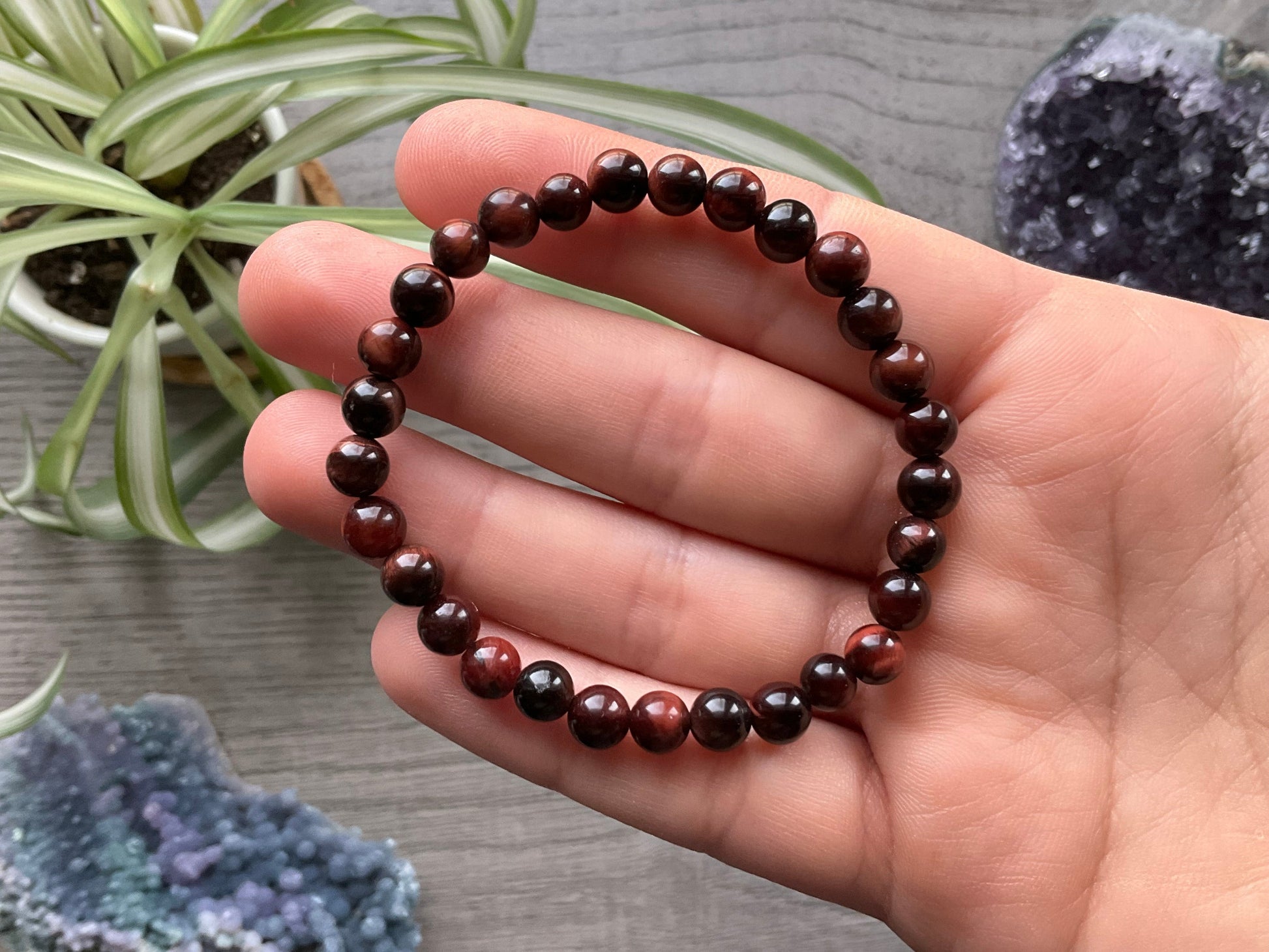Pictured is a red tiger's eye bead bracelet.
