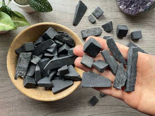 Pictured are various pieces of raw shungite.