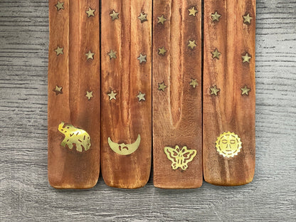 Pictured are various wood and brass inlay incense stick holders.