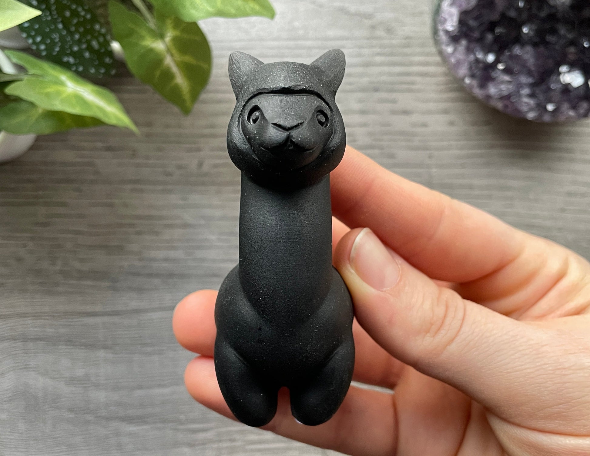 Pictured is a carved black obsidian alpaca or llama.