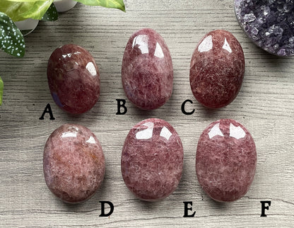 Pictured are various polished strawberry quartz (hematoid quartz with mica) stones.