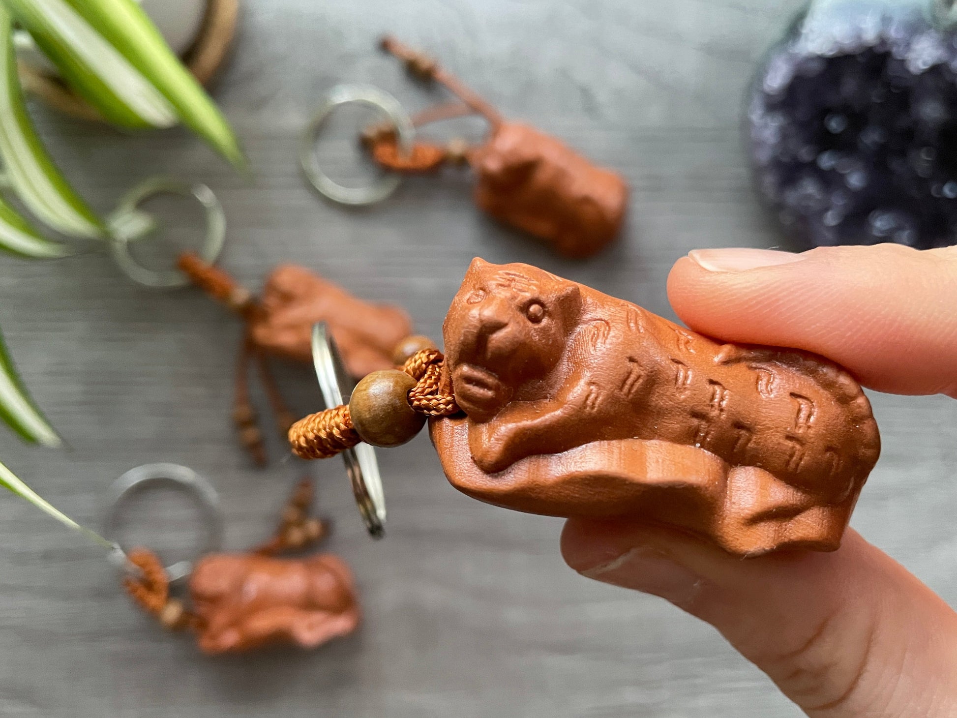 An image of a hand-carved wood tiger on a keychain.