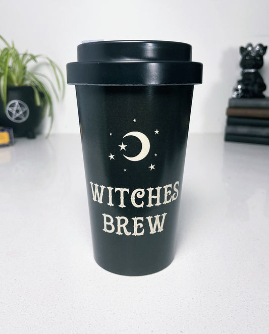 A black eco travel mug with a white words that say "Witches Brew" on the side. 