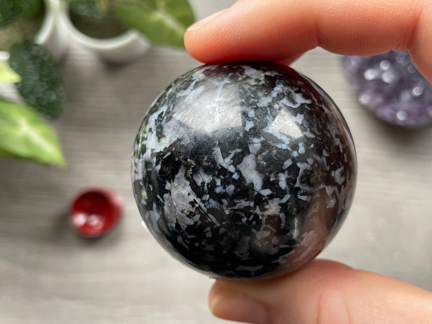 Pictured is a sphere carved out of indigo gabbro (mystic merlinite). 