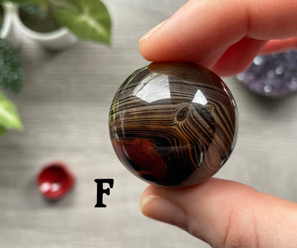 Pictured is a sphere carved out of sardonyx agate.
