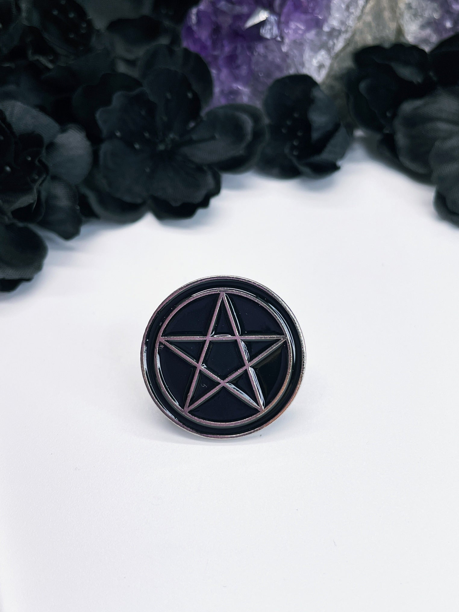 Pictured is an enamel pin of a pentagram
