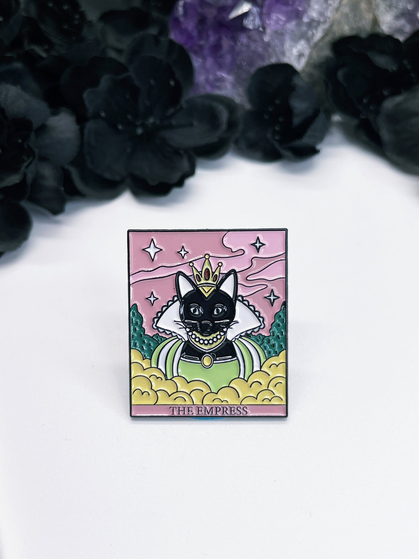  An enamel pin featuring a tarot card with a black cat on it, the card is "The Empress."
