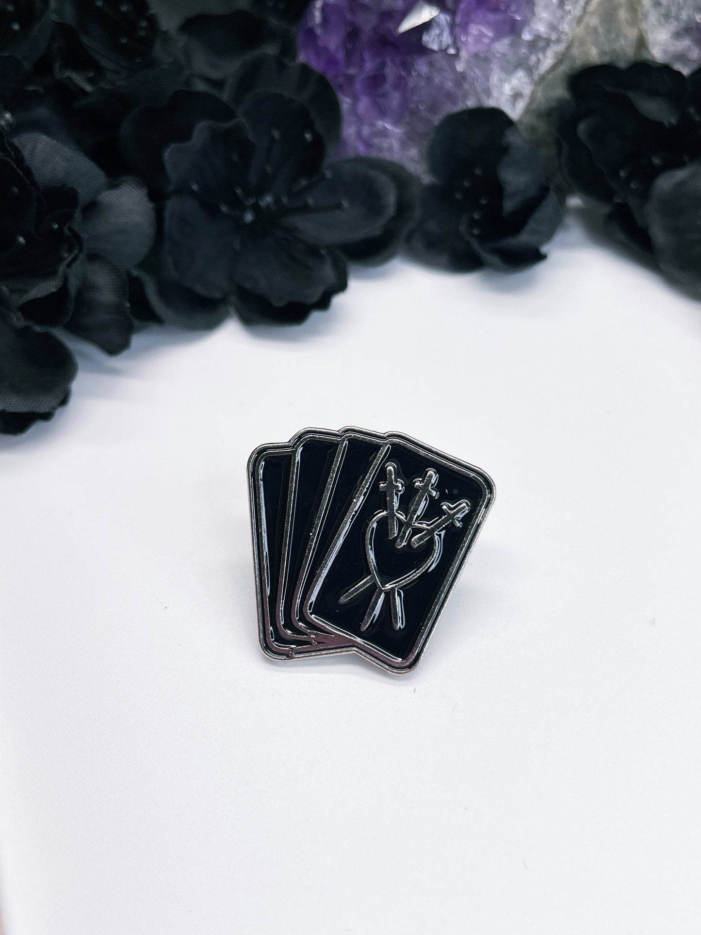 Pictured is an enamel pin of three tarot cards